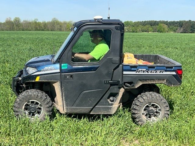 Surveyor conducting GPS site survey in Wisconsin farmland